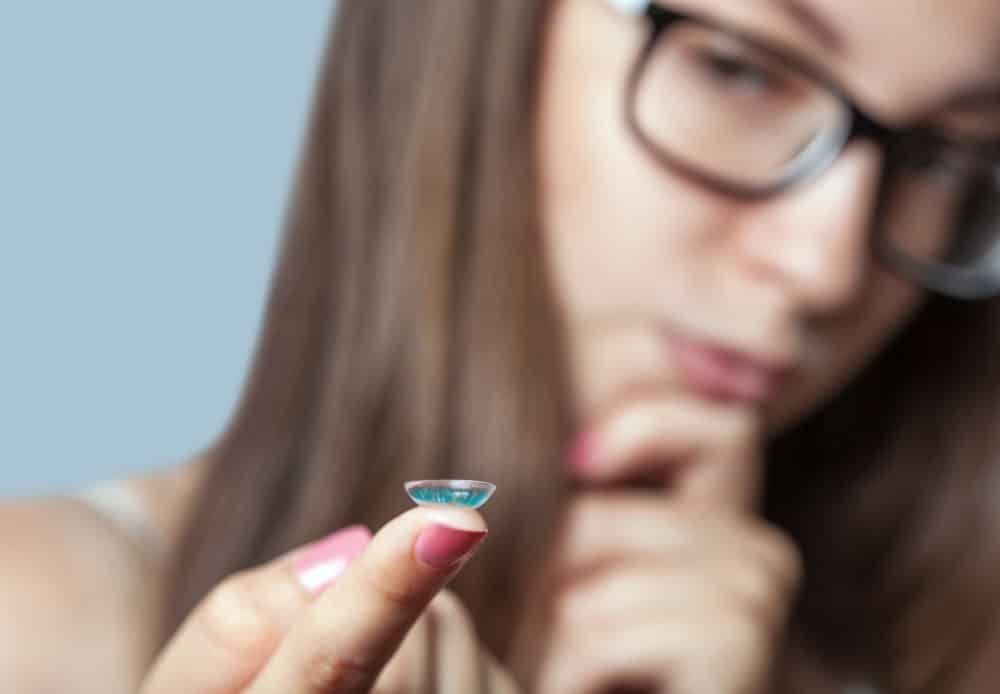 Image of Woman Holding Contact Lens On Finger